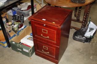 A wooden two drawer filing chest