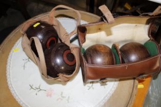 A pair of cased bowling woods and a modern pair of