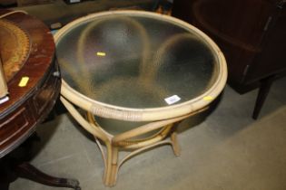 A bamboo and glass circular occasional table
