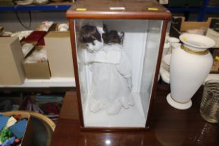 A dressed doll in display case