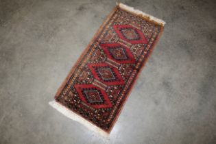 An approx. 2'2" x 1' Bokhara mat