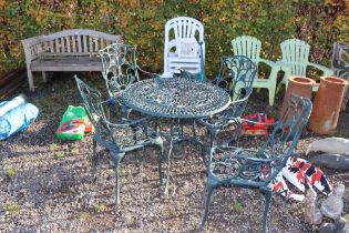 An ornate metal garden table and set of four chair