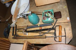 Three stirrup pumps, a BP oil can and advertising