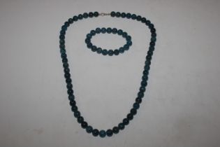 A blue polishes stone necklace and matching bracel