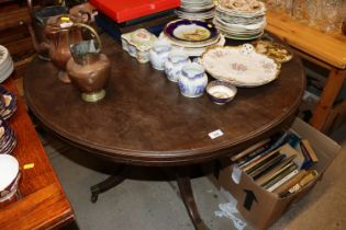 A circular mahogany dining table on central column