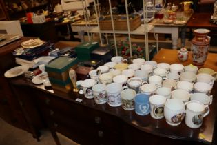 A large collection of various commemorative plates