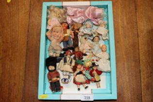 A small box of souvenir dolls etc.