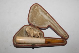 A cased Meerschaum pipe decorated with buffalo AF