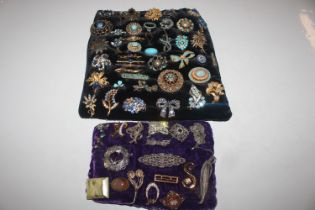 Two cushions of various decorative costume brooche