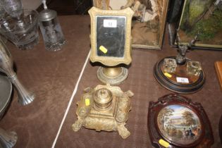 A brass swing frame mirror; and an ornate brass in