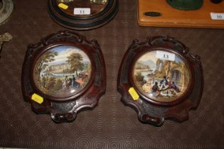 Two pot lids contained in carved mahogany frames,