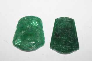 Two carved jade coloured pendants