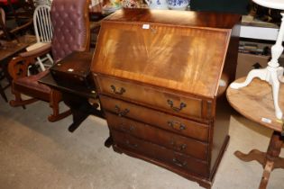 A mahogany bureau fitted four graduated drawers