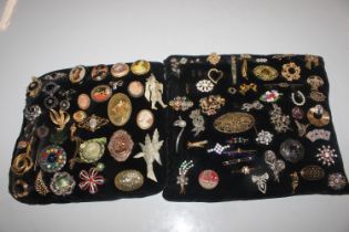 Two cushions of various decorative costume brooche