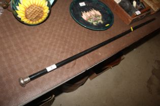 An ebonised and silver topped walking cane