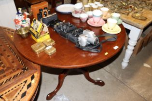 A mahogany circular topped table raised on tripod