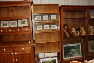 An oak open fronted bookcase with six fitted shelv