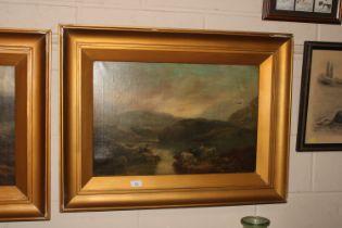 A gilt framed oil on canvas depicting cattle water