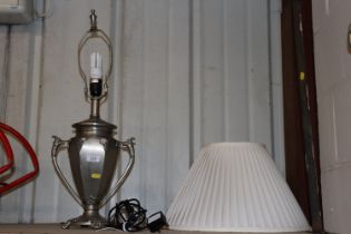 A heavy cast urn shaped table lamp with vine decor