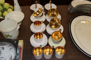 A set of six tea cups and saucers with gilt interi