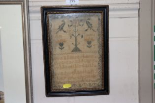 A small framed and glazed sampler dated 1835