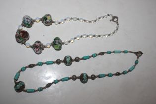 A white metal necklace with turquoise coloured bea