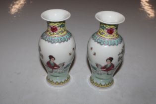 A pair of Chinese vases, painted in coloured ename