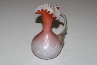 A satin glass ewer with frilled rim