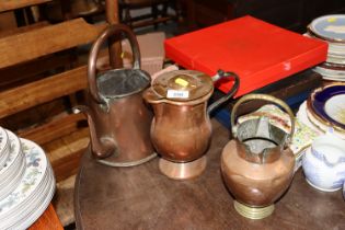 An antique copper and brass jug, kettle and one ot