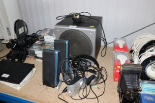 A sub speaker, two Logitech speakers and headset