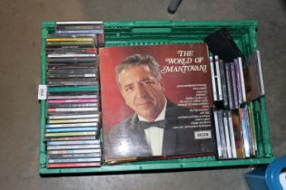 A plastic crate containing CDs and LPs