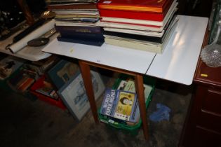 A vintage drop leaf kitchen table