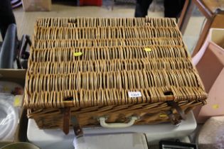 An Ideal Standard sink with a wicker picnic basket