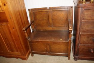 An oak monks bench with under seat storage