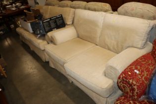 An upholstered three seater settee and matching tw