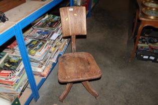 An oak adjustable swivel chair