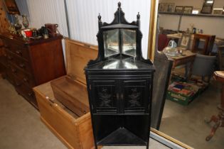 A late Victorian ebonised two door corner cupboard