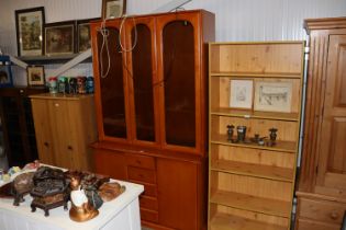 A modern display cabinet raised on cupboard base,