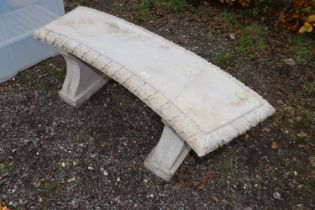 A concrete garden bench raised on two plinths AF