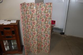 A floral upholstered four fold screen