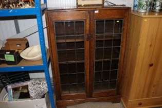 An oak and leaded glazed bookcase