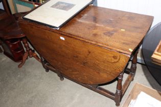 An antique oak gate leg table