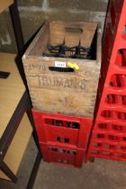 A wooden bottle crate named to Truman's and two pl