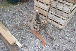 A pair of cast iron bench ends with lion mask deco