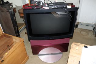 A Bang & Olufsen tv with remote control and instruction manuals