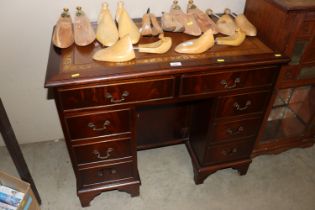 A reproduction mahogany knee hole desk fitted with