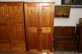 A modern pine two door wardrobe