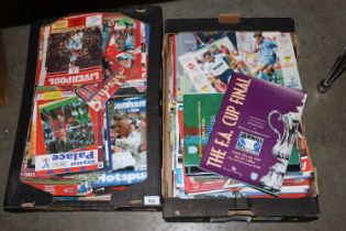 Two boxes of various football programmes