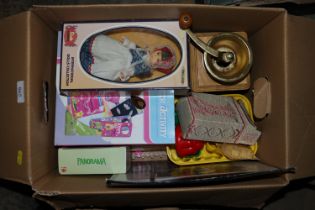 A box containing a coffee grinder and various toys