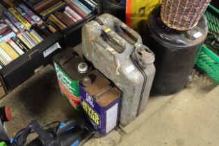 A metal jerry can and two vintage motor oil tins